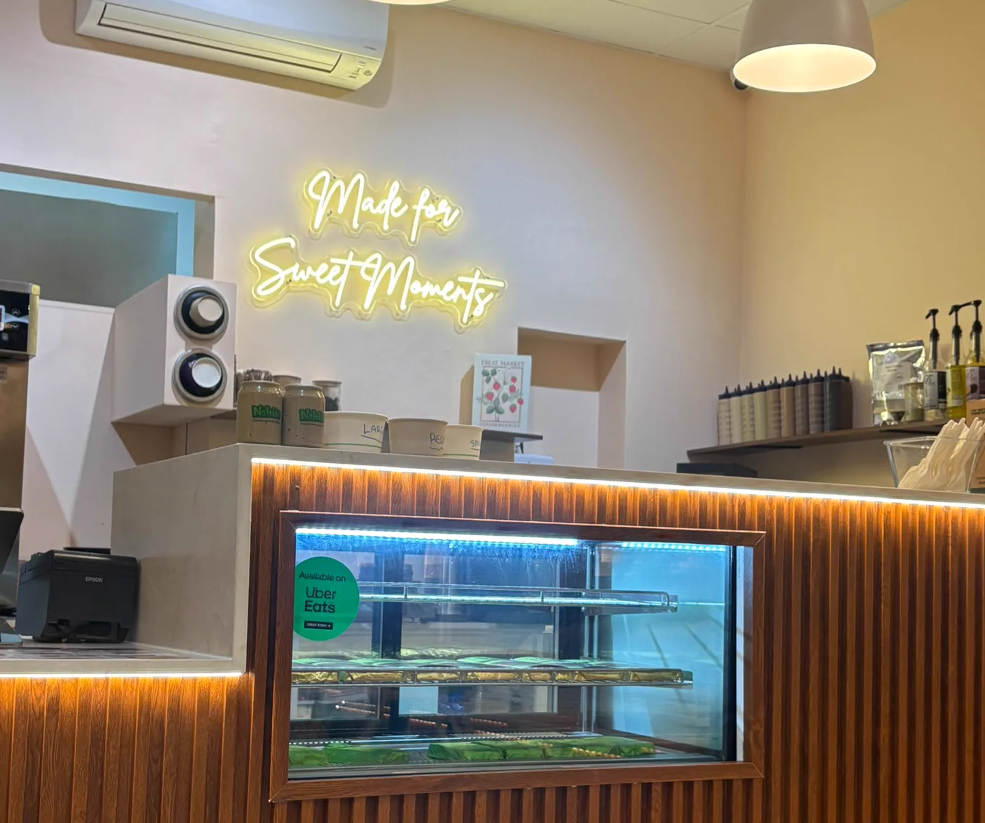 Made for Sweet Moments in neon above the counter at Nabil's Mount Lawley shop.